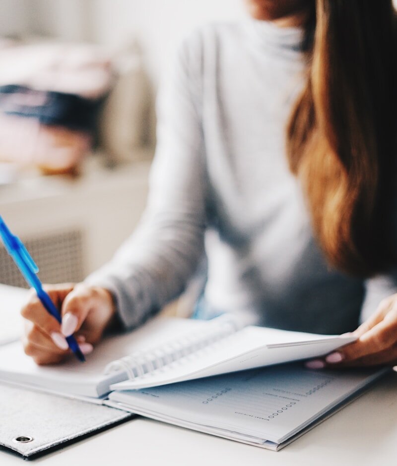 woman writing using pen